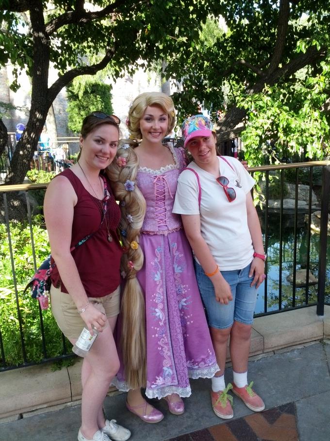 my sister and myself posing with Rapunzel at Disneyland