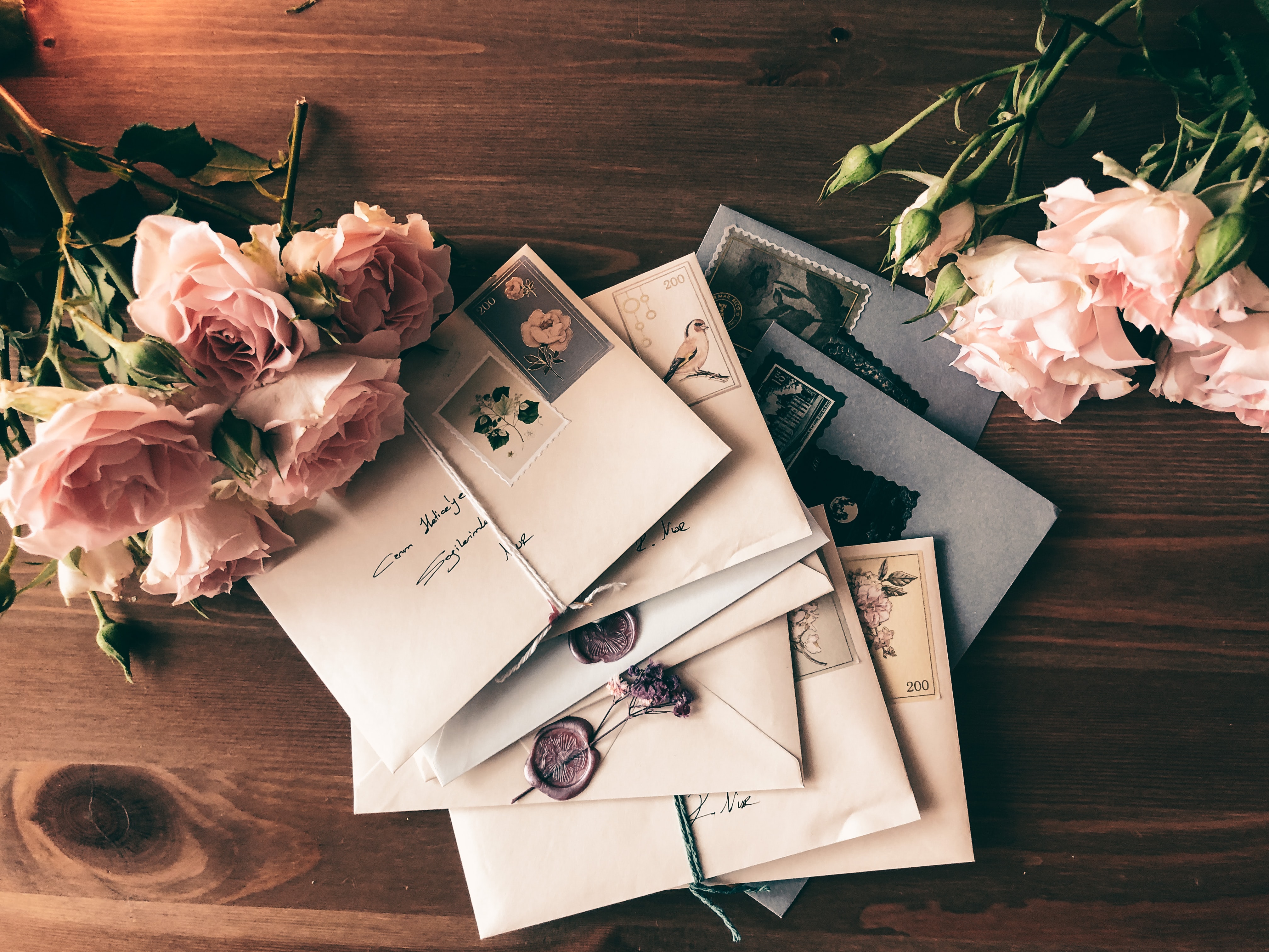 old hand-addressed envelopes surrounded by flowers